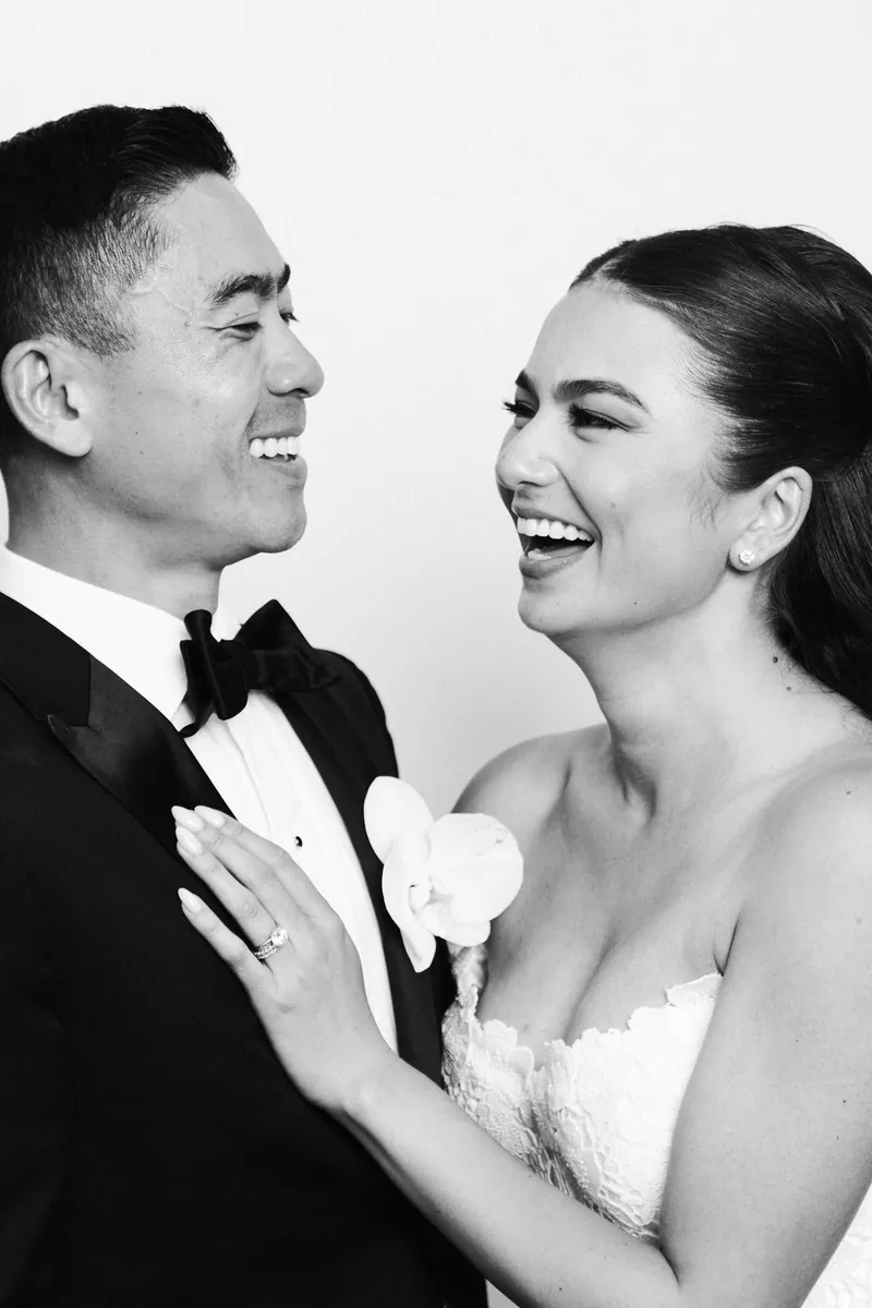 Bride laughing with groom, black and white