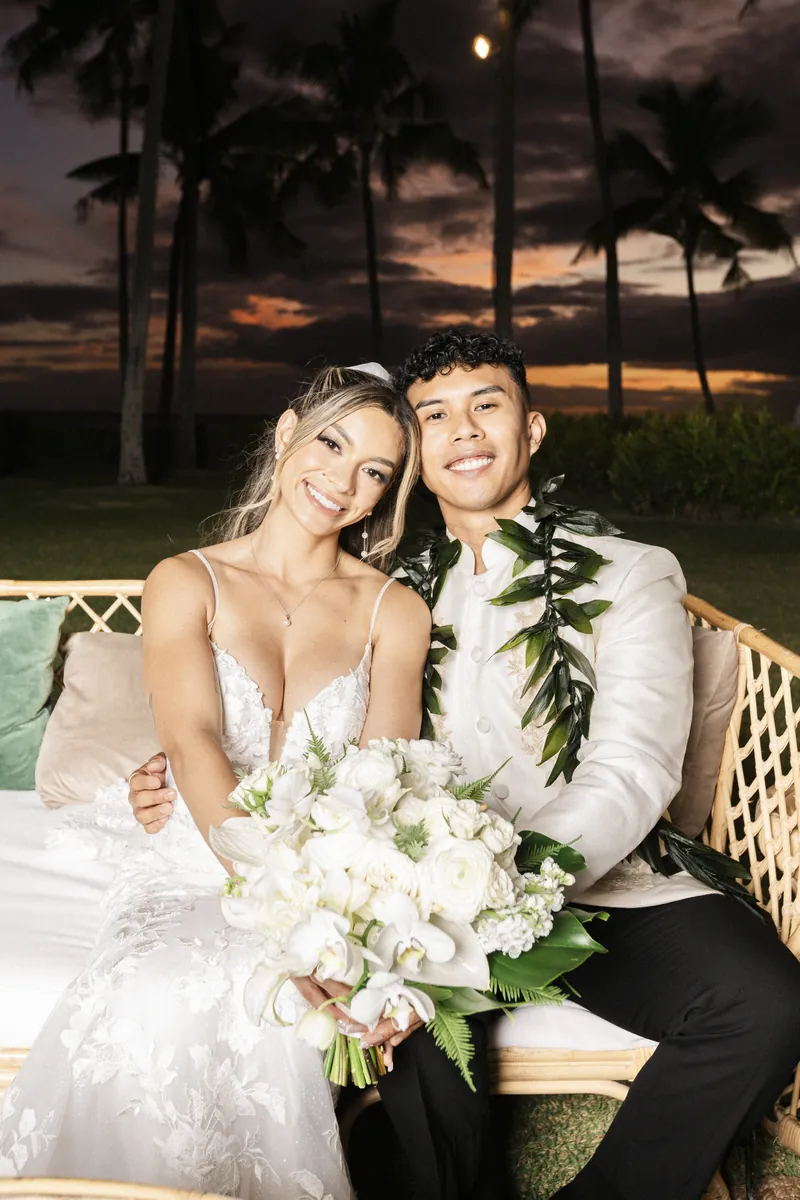 Newlyweds on a lounge set at night
